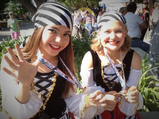 Two smiling dancers in recital costumes